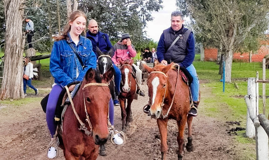 students and a professor riding horses in Argentina