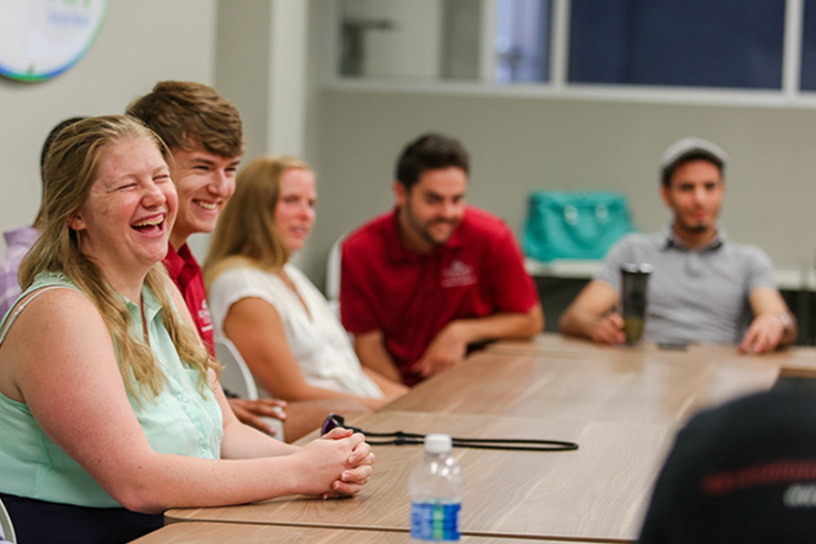 students laughing at a roundtable event