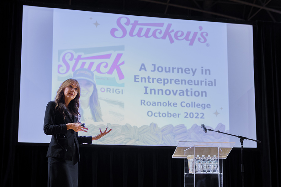 2022 speaker Stephanie Stuckey, CEO of Stuckey’s, addressing audience in front of a projector screen 