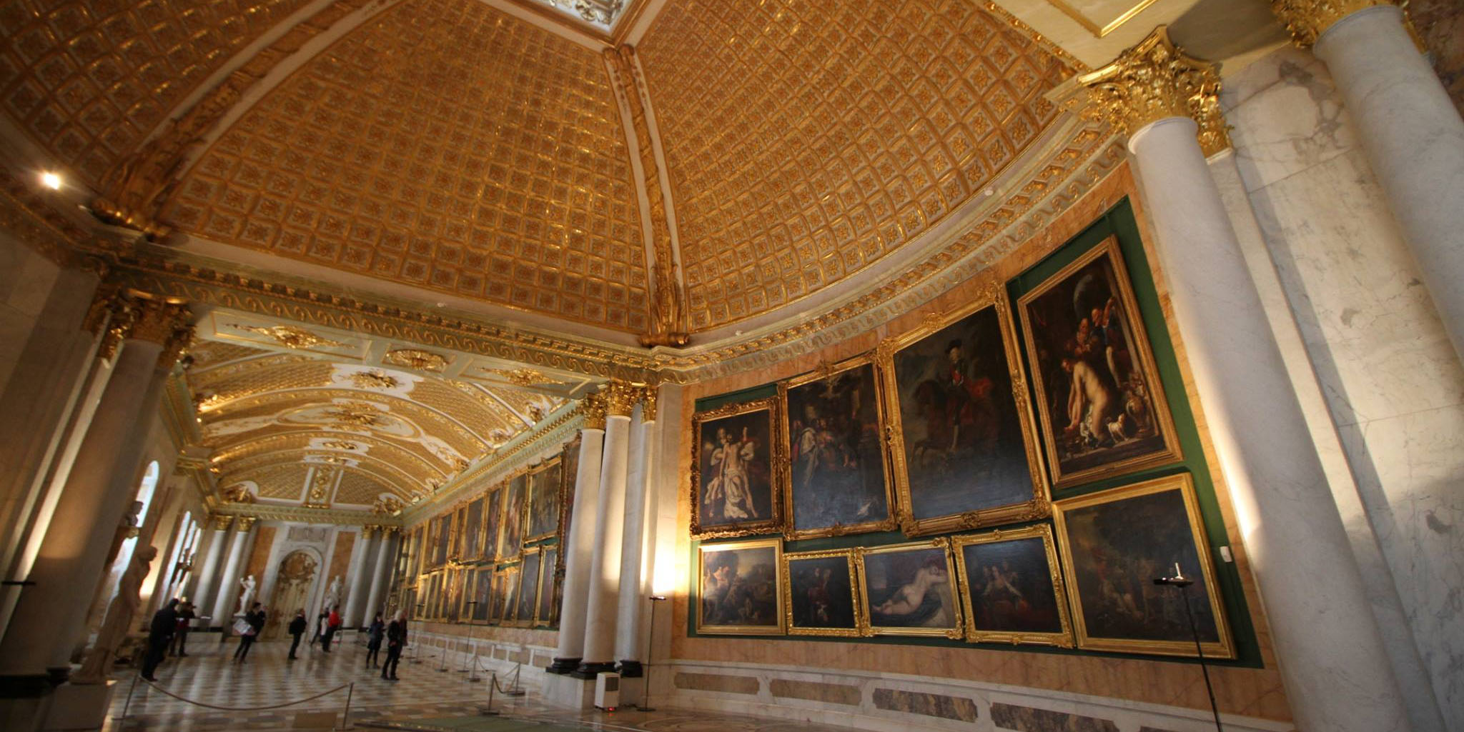 Photo of the elaborately molded, golden palace ceiling