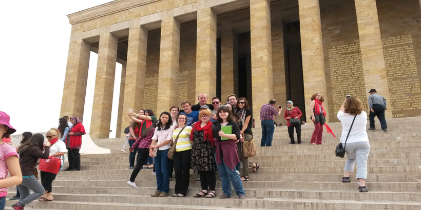 Students and faculty pictured on the sweeping stone steps of a historical site