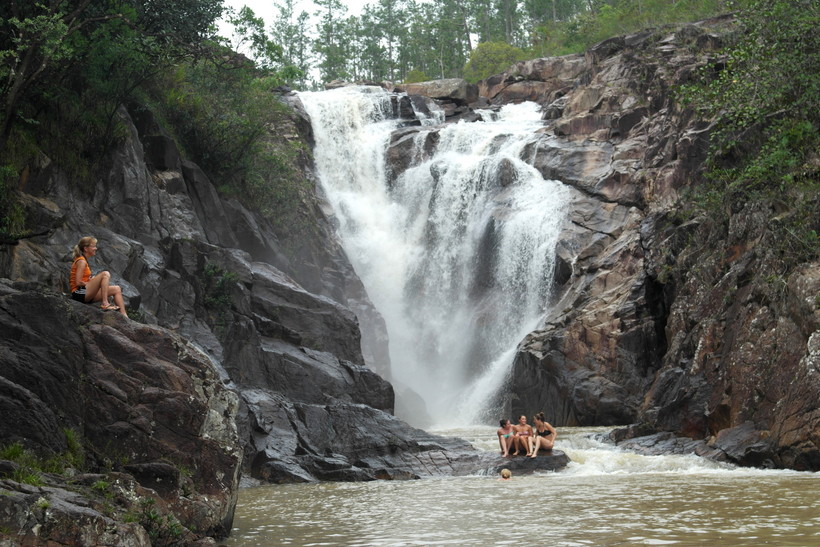 Students by a waterfall in a Latin American country