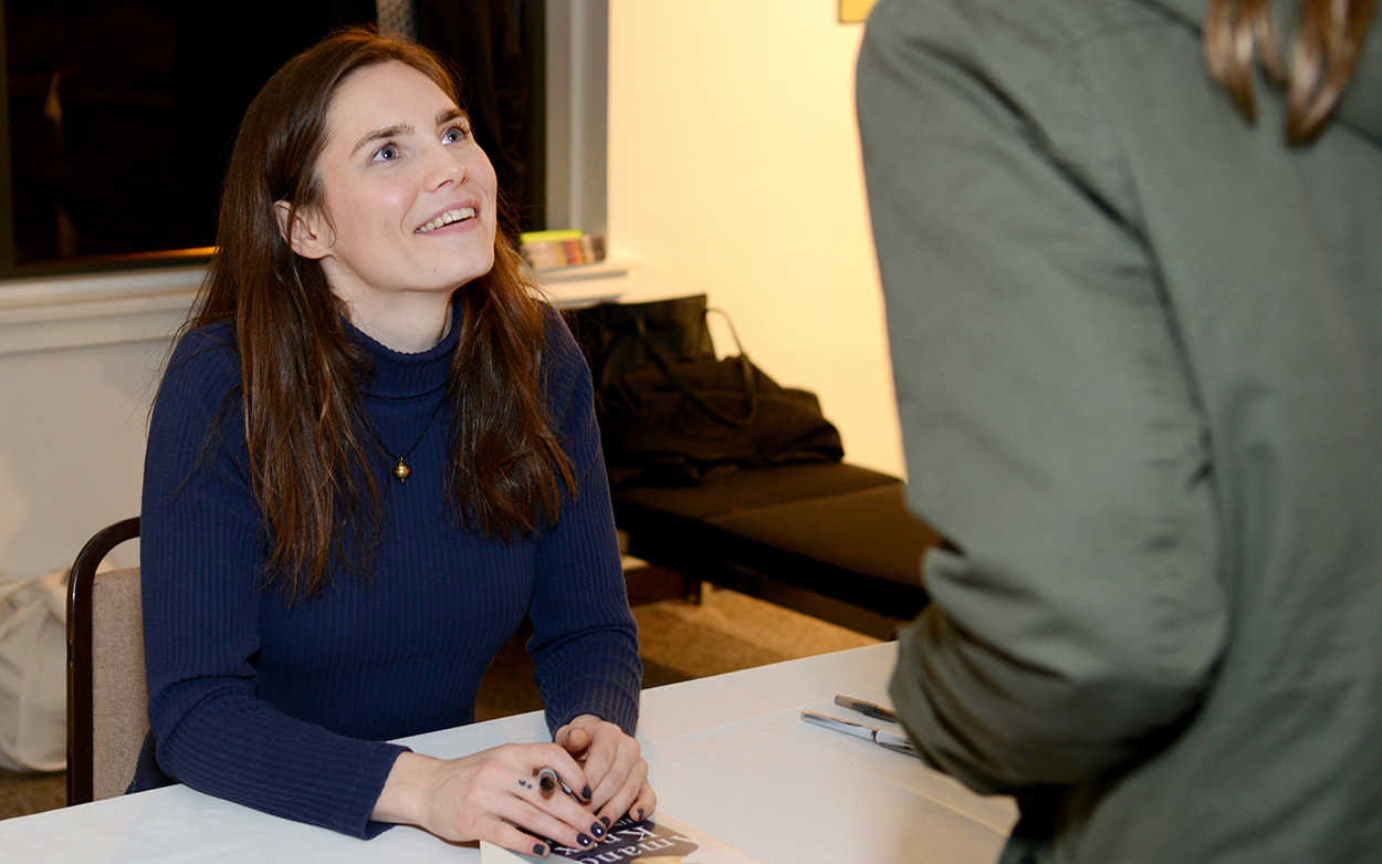 Amanda Knox signing a copy of her own book