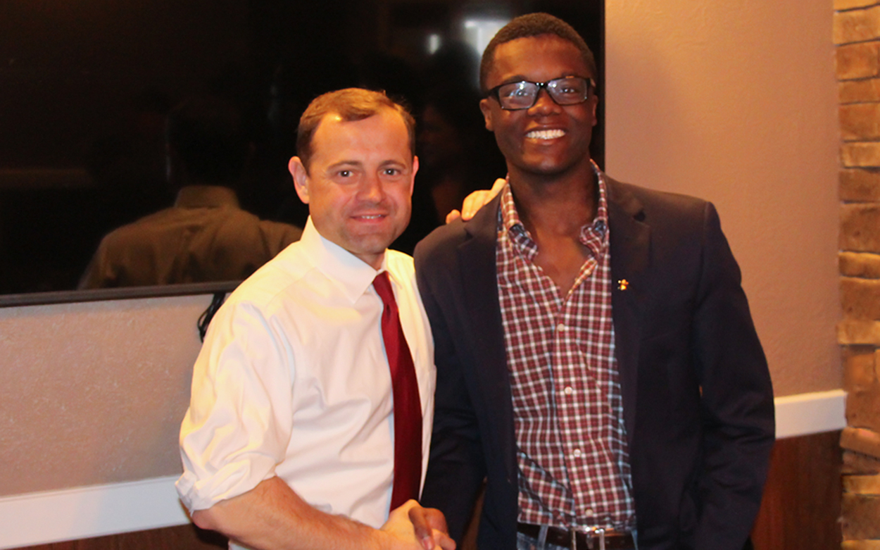 Tom Perriello shaking hands with Myles Cooper '18