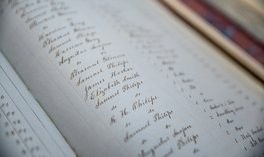 Student researchers with CSSR have pored over handwritten record books, like this one in Roanoke County archives, in an effort to learn more about the enslaved people who contributed to the early growth of Roanoke College and the surrounding area.