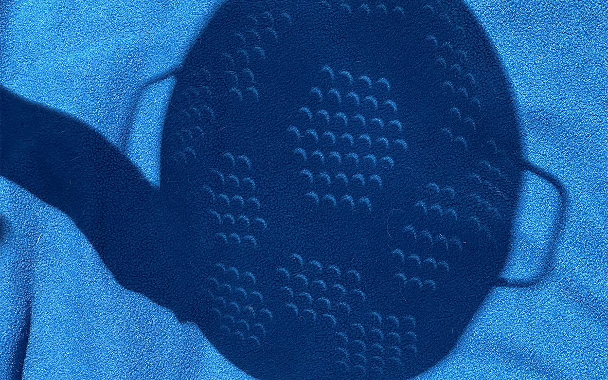 crescent shaped shadows show through a colander during the solar eclipse