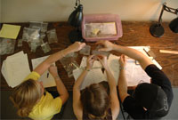 Students working with historic accessories in the library