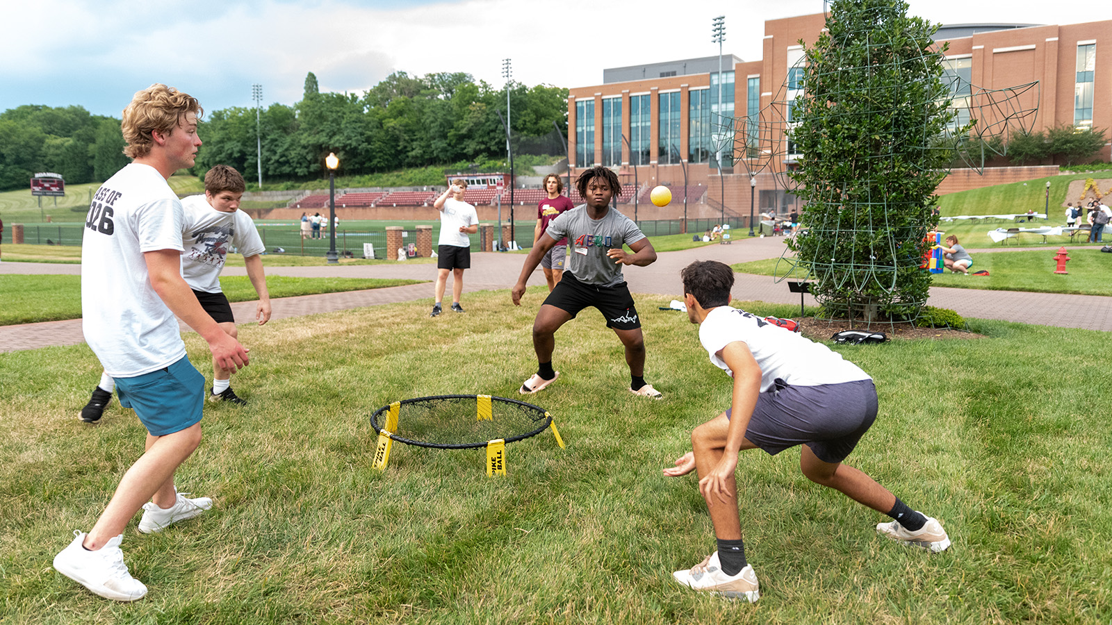 Students play Spike Ball on the Maroons Athletic Quad during summer orientation.
