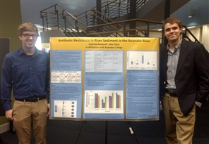 students presenting research poster