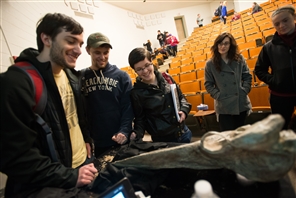 Students looking at fossil