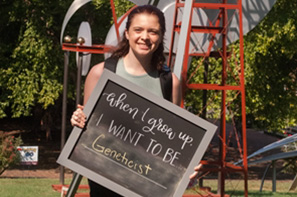 Student holding sign