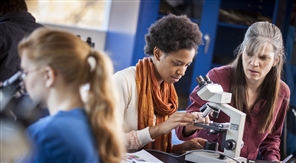 students looking in microscopes