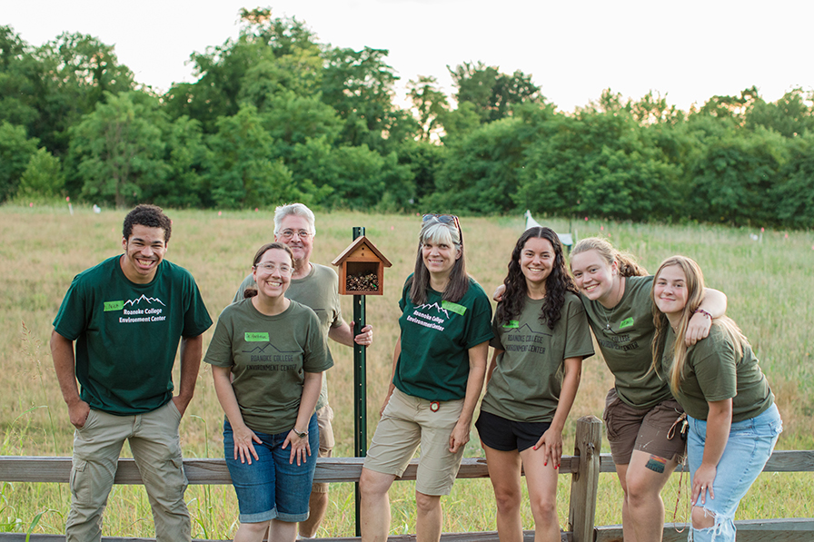 Rachel Collins with students and an insect house