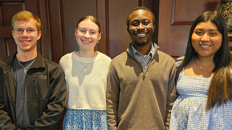 Four student fellows smile for a photo