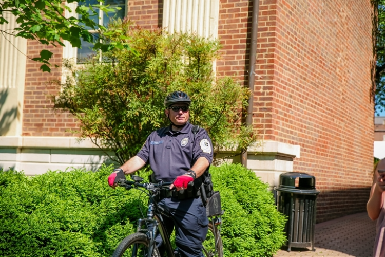 images/CAMPUS SAFETY/CampusSafety-2016-9.jpg Campus Safety officer on a bike