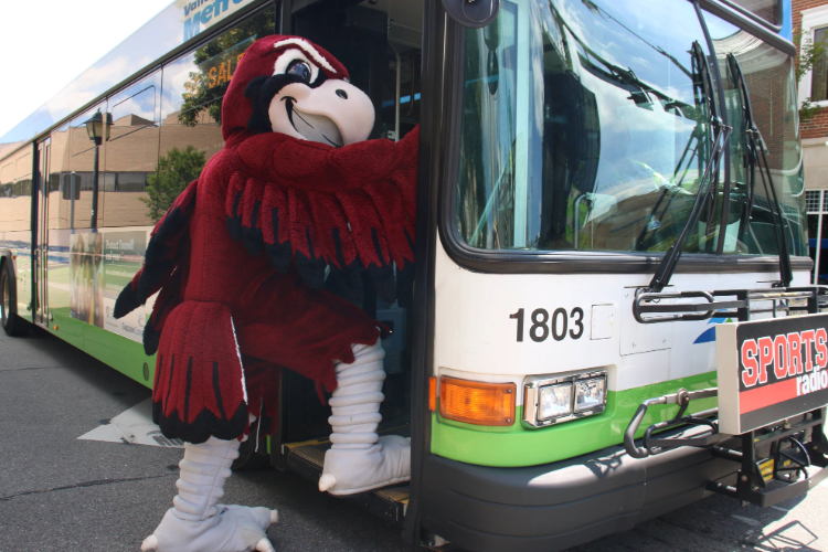 Mascot Rooney the hawk boards a bus