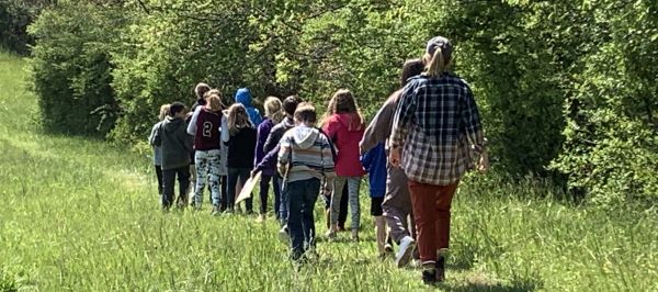 children walking through field