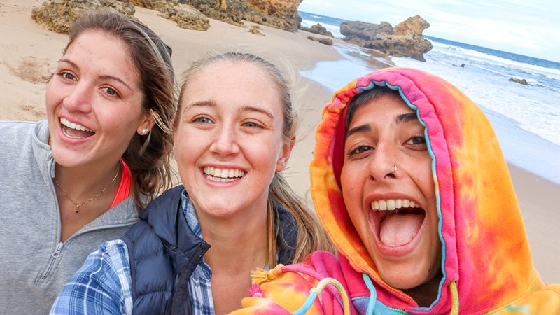 3 students on a beach