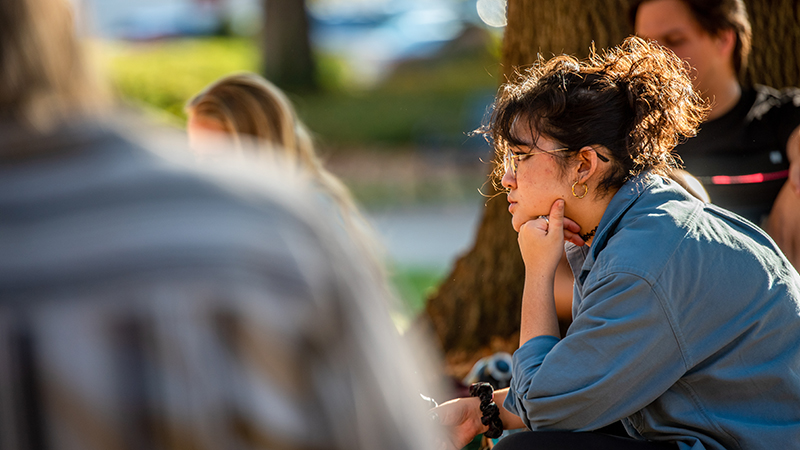 student sitting outside for class