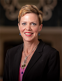 Head shot of dark-haired woman in dark blazer