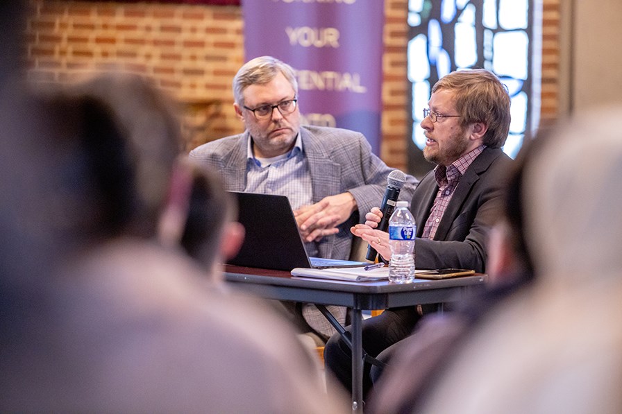 Dr. Jonathan Snow and Dr. Rob Willingham speak at a teach-in. 