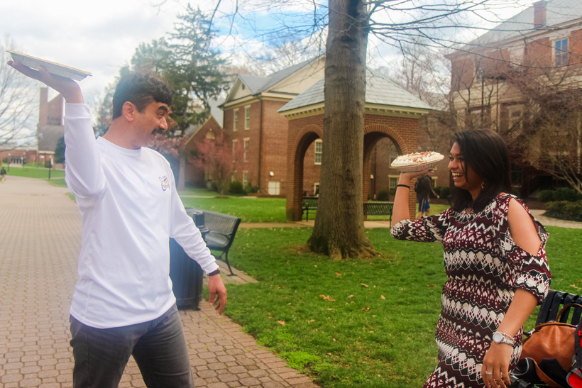 Student and professor getting ready to put pies in each other's faces