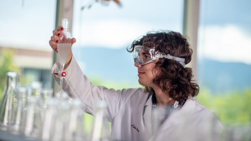 Student looking into a beaker