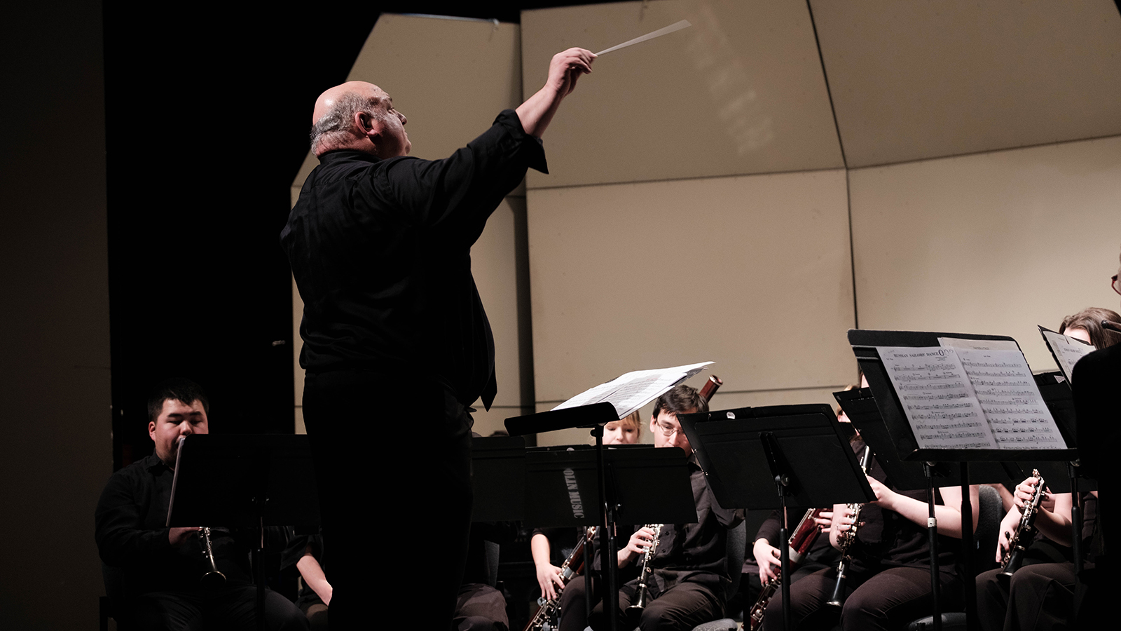 conductor stands in front of band