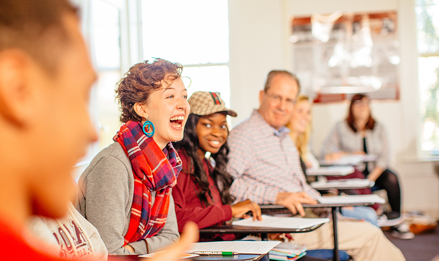 Students smiling and talking in class