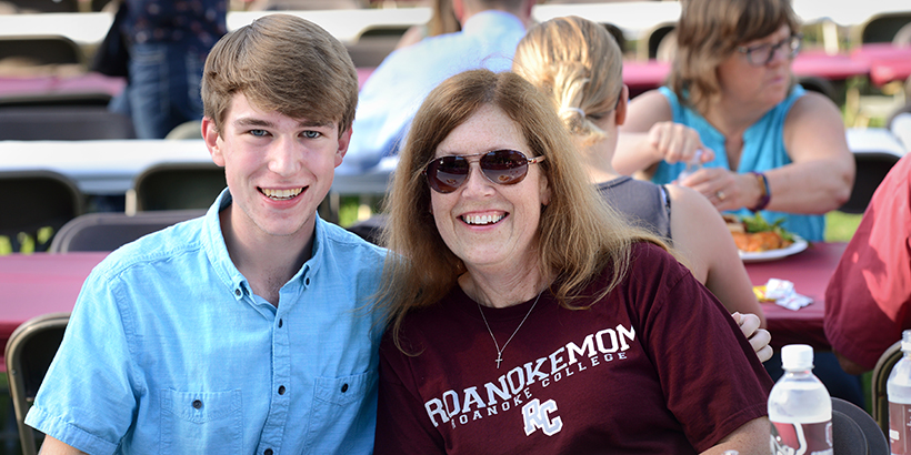 A student sitting with his mom