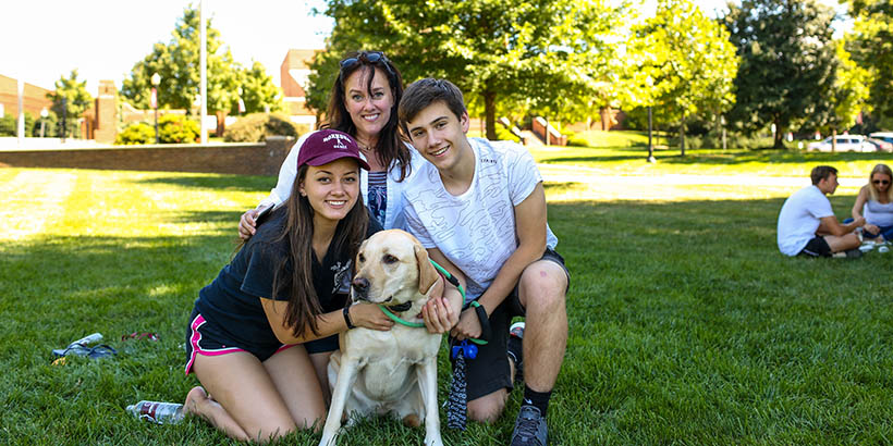 A family on the back quad with their dog