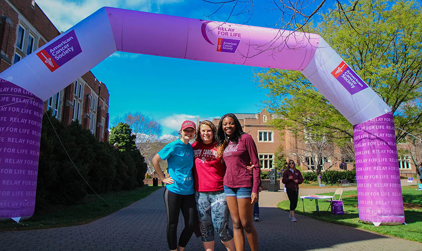 students underneath the relay for life arch