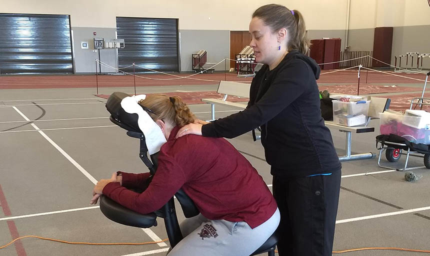 A member of the faculty getting a chair massage