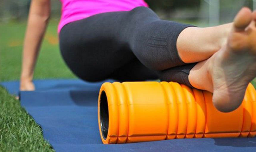 A person using a foam roller on their feet