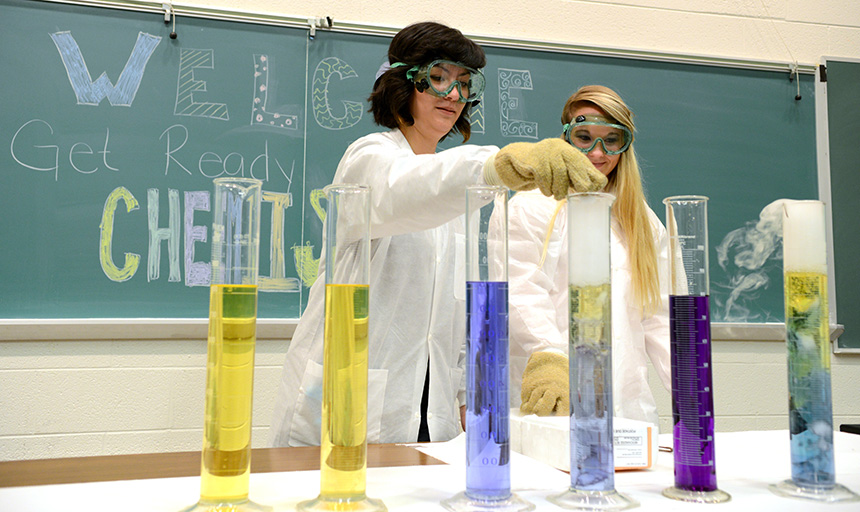 Two students doing a chemical experiement 