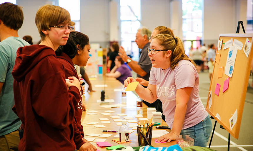 students talking to one another at an activties fair