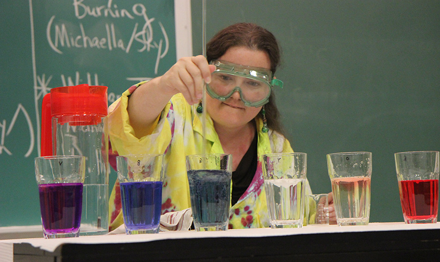 Student mixing chemicals