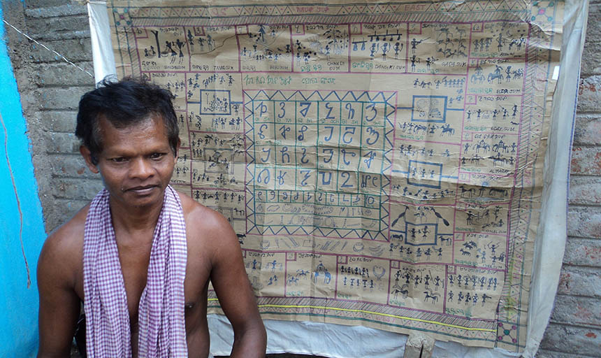 A photo of a man standing in front of a carpet written on in a foreign language