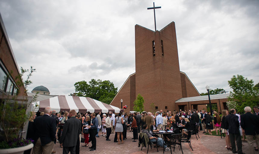 people standing outside chapel