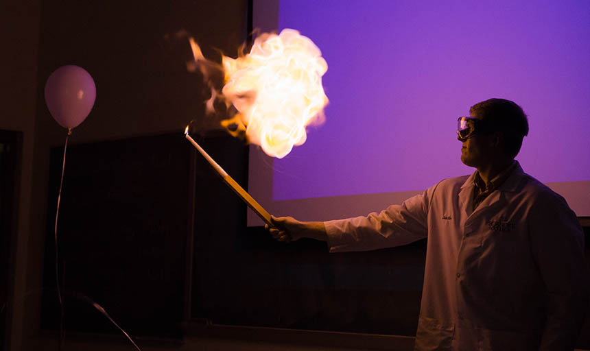 A student experimenting with an exploding balloon