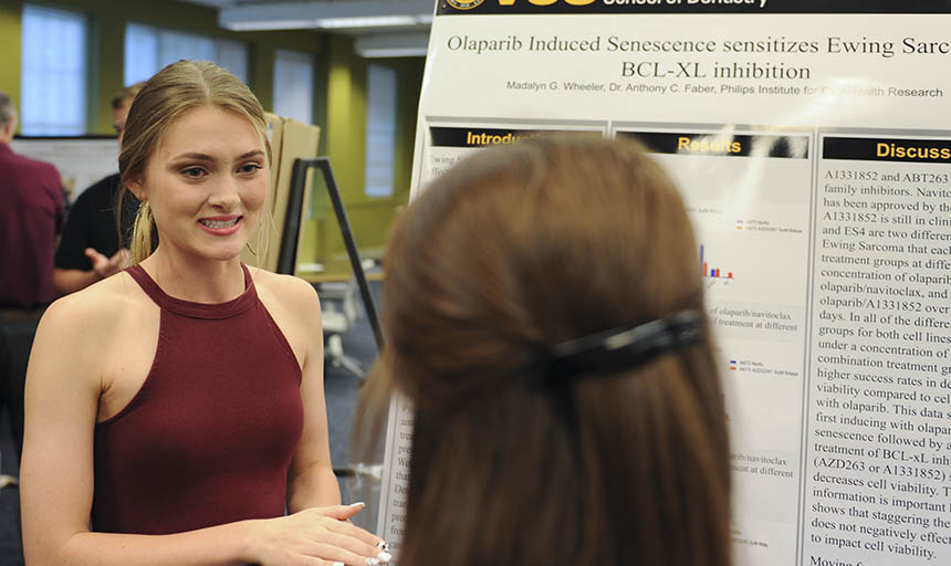 A student presenting her research