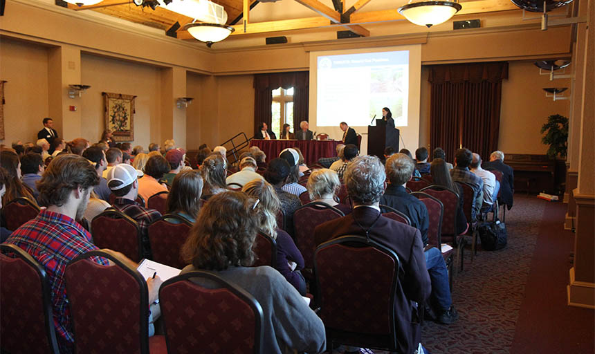 Large group of people watching a presentation in a ballroom 