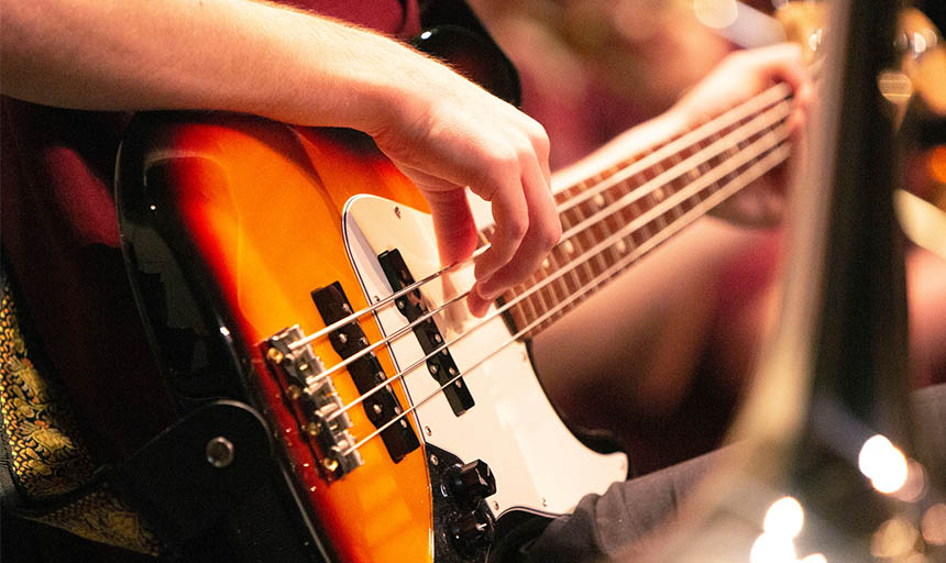 close up of someone playing an electric guitar 