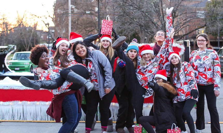 A group of students together smiling and ice skating