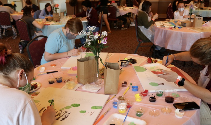 Students participating in paint and wine night