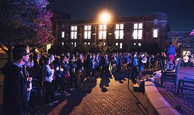 students gather around the colket patio at night to raise awareness for sexual misconduct