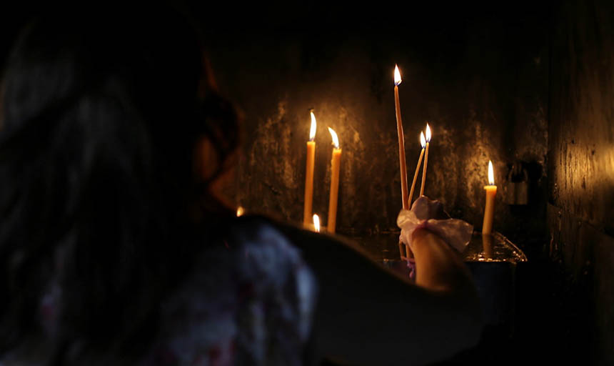 person holding candles in the dark