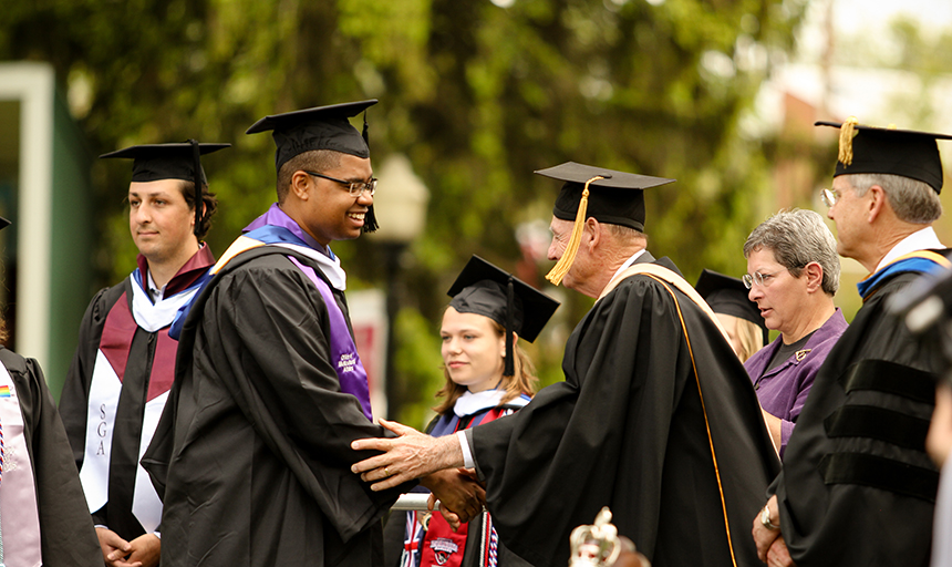 Roanoke college student receiving congratulations on commencement day