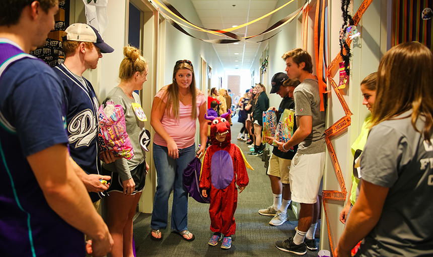 Student athletes handing out candy to children