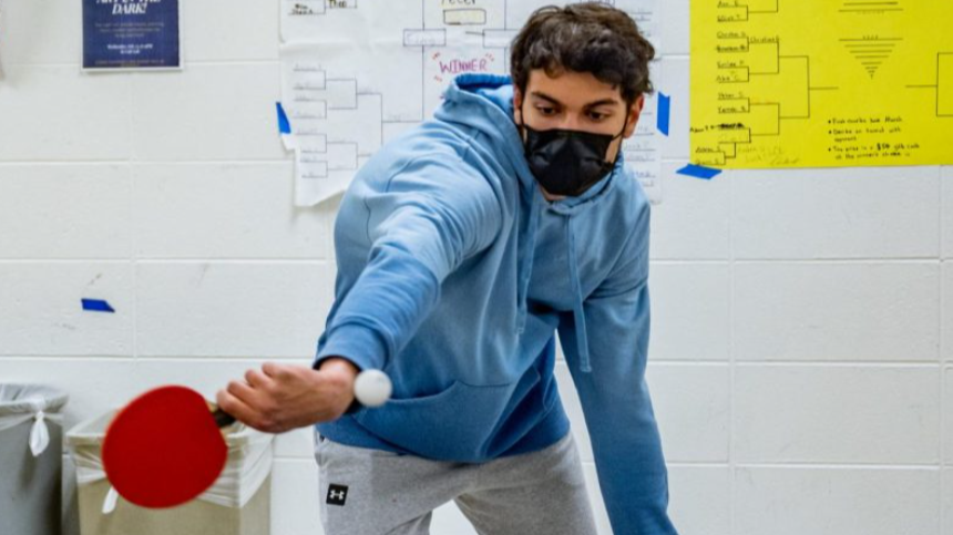 Student playing ping pong